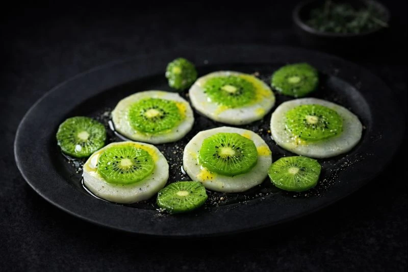 かぶとキウイのカルパッチョ。薄くスライスした素材にオリーブオイルとブラックペパーをかけた一皿